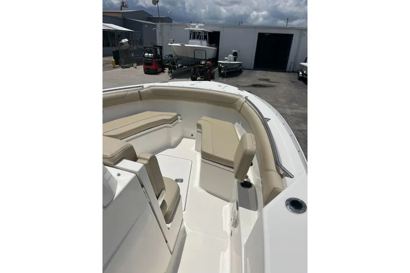 Slide: The Image of 2019 Pursuit S 288 Sport boat interior with beige seating and sleek design. - 7