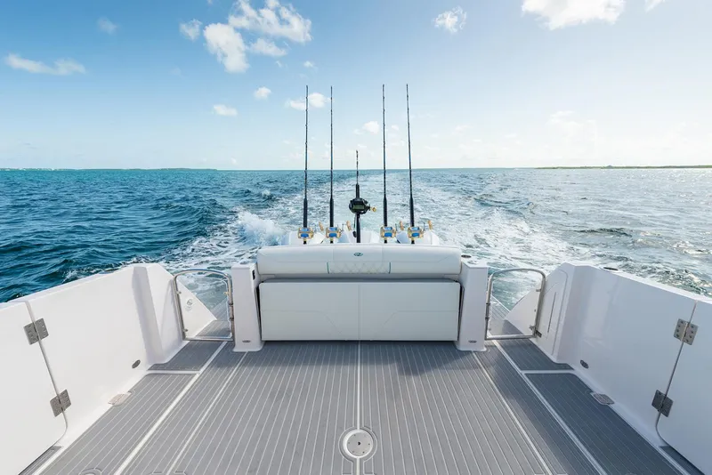 Slide: The Image of Manufacturer Provided Image: 2026 Regal 38 SAV boat deck with fishing rods, cruising on open sea. - 6
