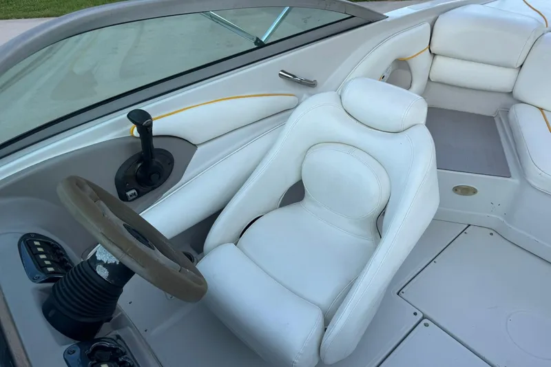Slide: The Image of 2005 Crownline 210 Razor boat interior with white seating and steering wheel. - 11