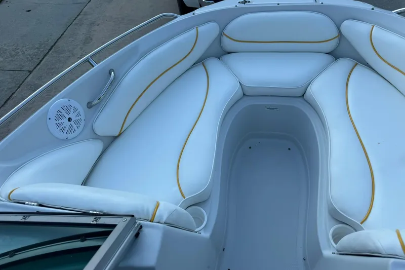 Slide: The Image of 2005 Crownline 210 Razor boat interior with white seating and yellow accents. - 4