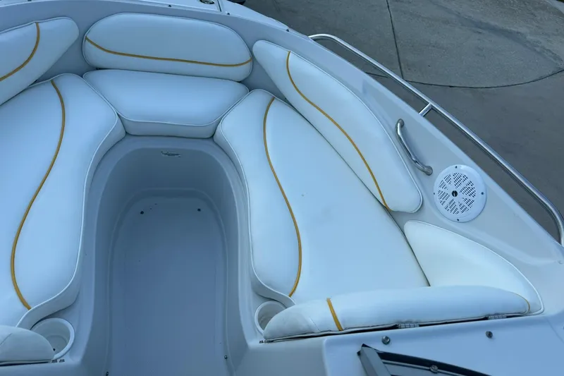 Slide: The Image of 2005 Crownline 210 Razor boat interior with white seating and yellow accents. - 5