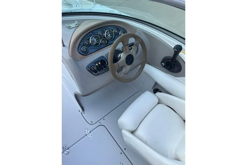 Slide: The Image of 2005 Crownline 210 Razor boat cockpit with steering wheel and control panel. - 7