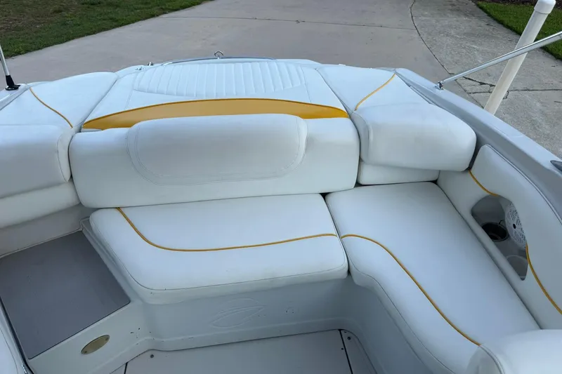 Slide: The Image of 2005 Crownline 210 Razor boat interior with white and yellow cushioned seating. - 9