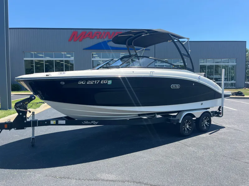 Slide: The Image of 2024 Sea Ray 21 SPX boat on trailer in front of building. - 2