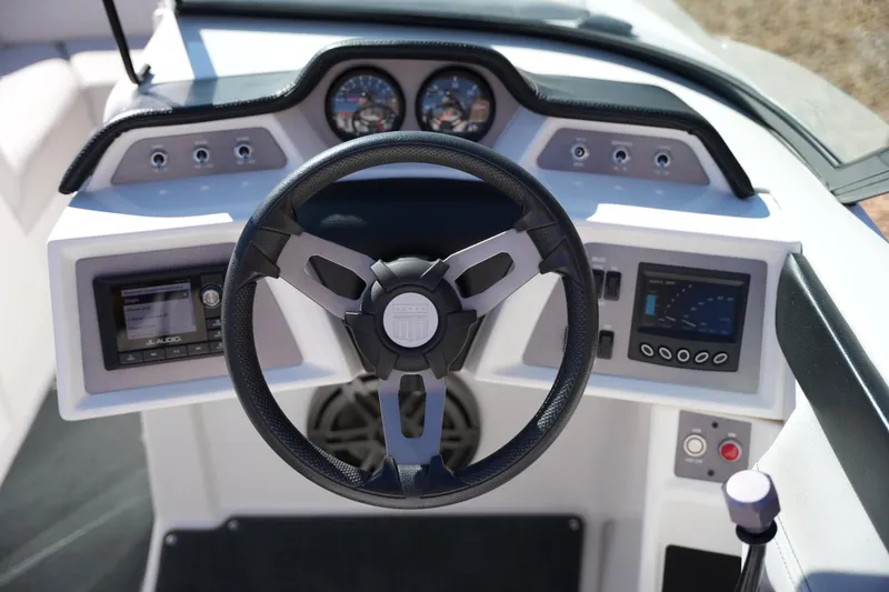Slide: The Image of 2020 MasterCraft NXT20 boat dashboard with steering wheel and control panels. - 12