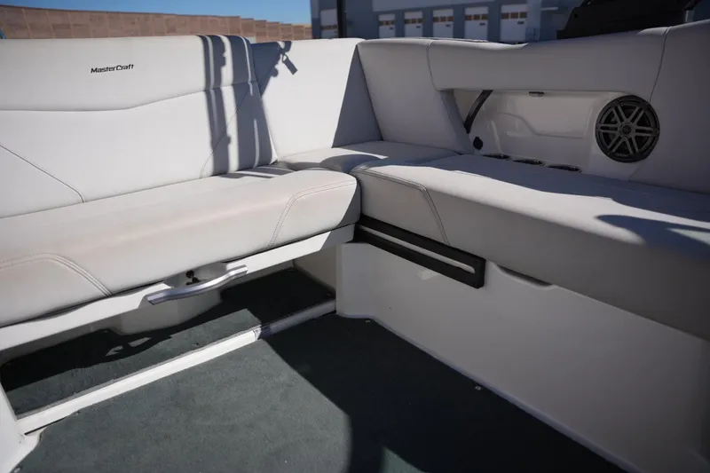 Slide: The Image of 2020 MasterCraft NXT20 boat interior with white seating and speaker detail. - 13