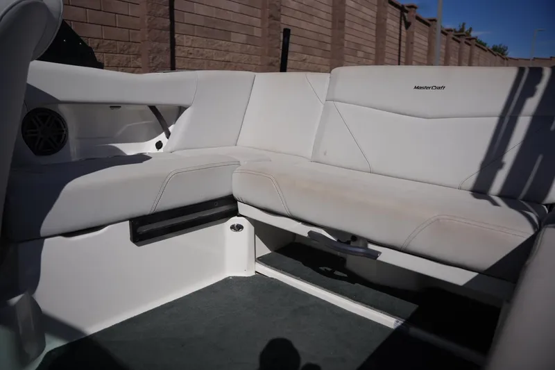 Slide: The Image of 2020 MasterCraft NXT20 boat interior with white seating and speaker detail. - 14