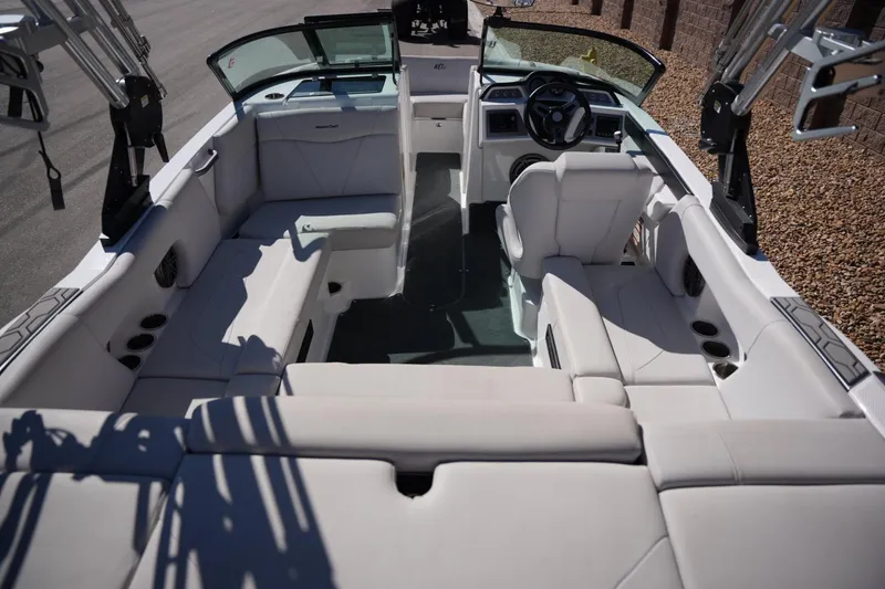 Slide: The Image of 2020 MasterCraft NXT20 boat interior with white seating and modern dashboard. - 20
