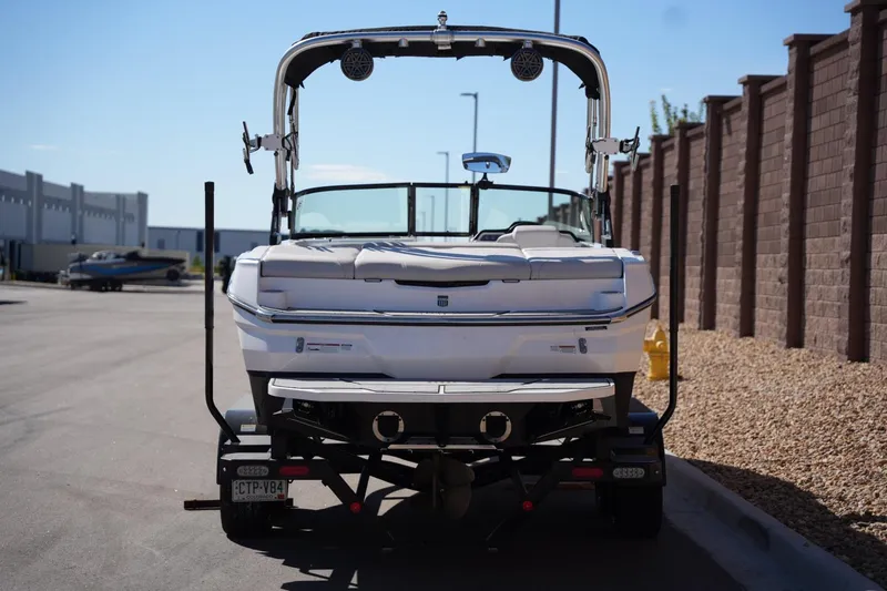 Slide: The Image of 2020 MasterCraft NXT20 boat on trailer, rear view, parked on a sunny day. - 3