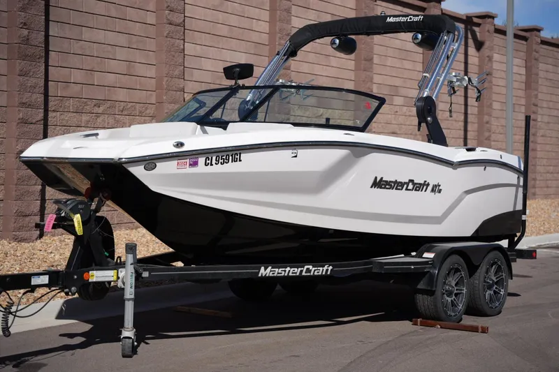 Slide: The Image of 2020 MasterCraft NXT20 boat on trailer, parked outdoors. - 8