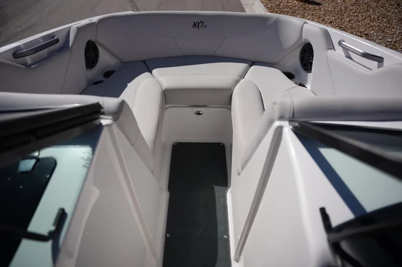 Slide: The Image of 2020 MasterCraft NXT20 boat interior with cushioned seating and speakers. - 9