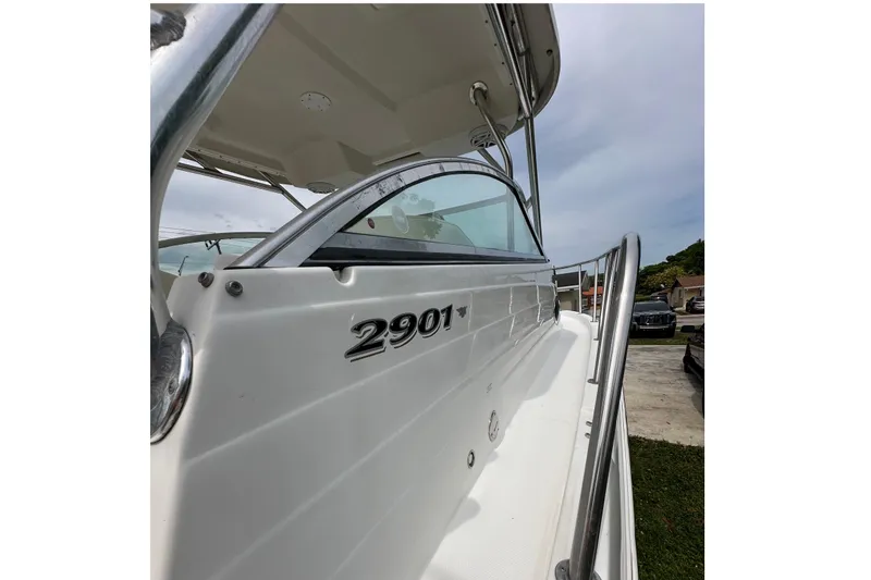Slide: The Image of 2005 Seaswirl Striper 2901 Walkaround O/B boat, side view with railing and logo. - 3