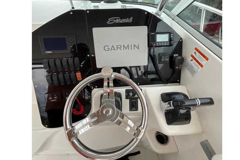 Slide: The Image of 2005 Seaswirl Striper 2901 Walkaround O/B helm with Garmin navigation system and controls. - 5