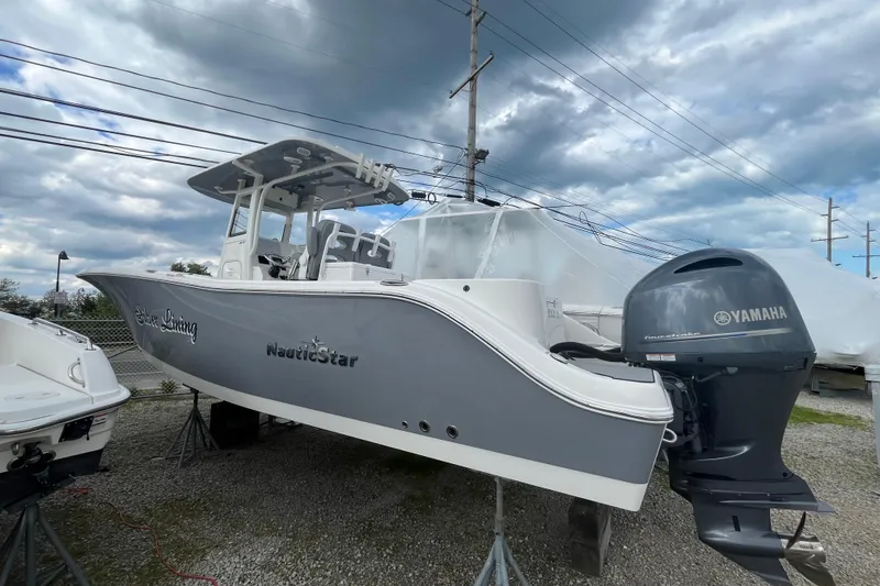 The Image of 2022 NauticStar 28 XS boat with Yamaha engine, displayed outdoors under cloudy sky. - 0