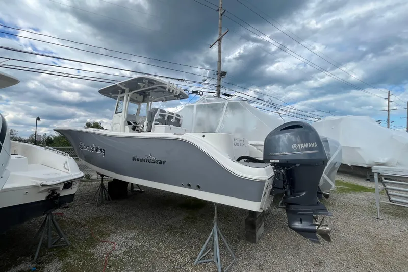 Slide: The Image of 2022 NauticStar 28 XS boat with Yamaha engine, displayed outdoors under cloudy skies. - 1