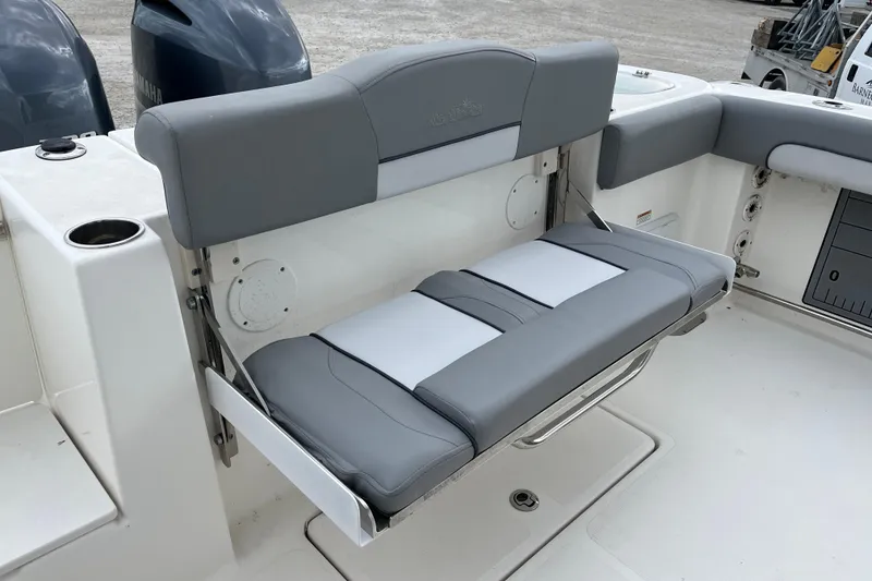 Slide: The Image of 2022 NauticStar 28 XS boat with gray seating and Yamaha engines. - 11