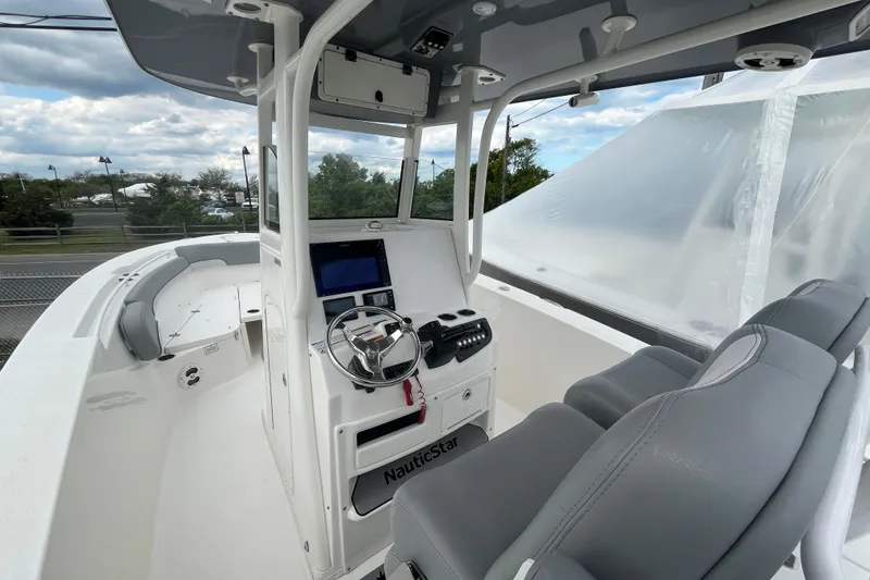 Slide: The Image of 2022 NauticStar 28 XS boat interior with helm, seating, and navigation equipment. - 3