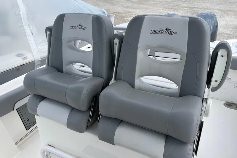 Slide: The Image of Gray and white NauticStar 28 XS boat seats, 2022 model, with armrests and logo. - 4