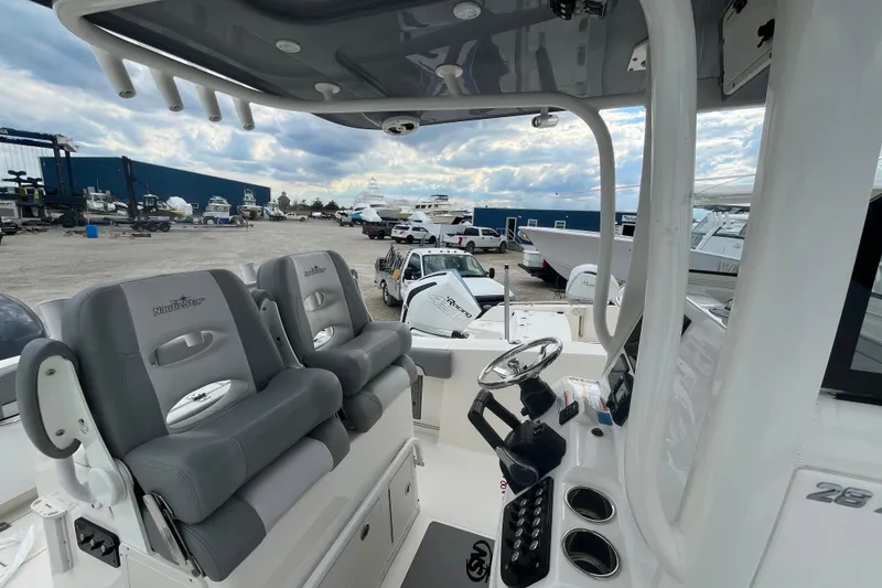 Slide: The Image of 2022 NauticStar 28 XS boat interior with dual seats and steering console. - 7