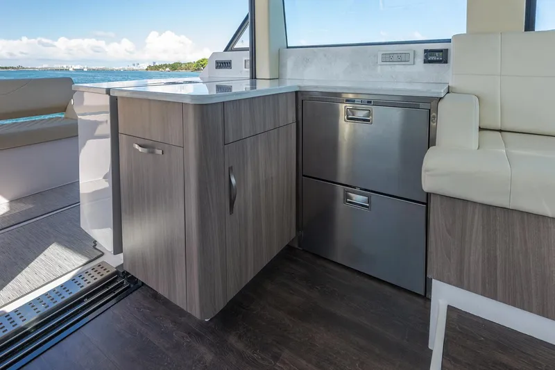 Slide: The Image of Manufacturer Provided Image: Modern interior of 2026 Regal 38 XO yacht with sleek cabinetry and stainless steel appliances. - 14
