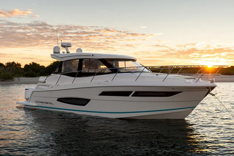 Slide: The Image of Manufacturer Provided Image: 2026 Regal 38 XO yacht cruising at sunset on calm waters. - 2