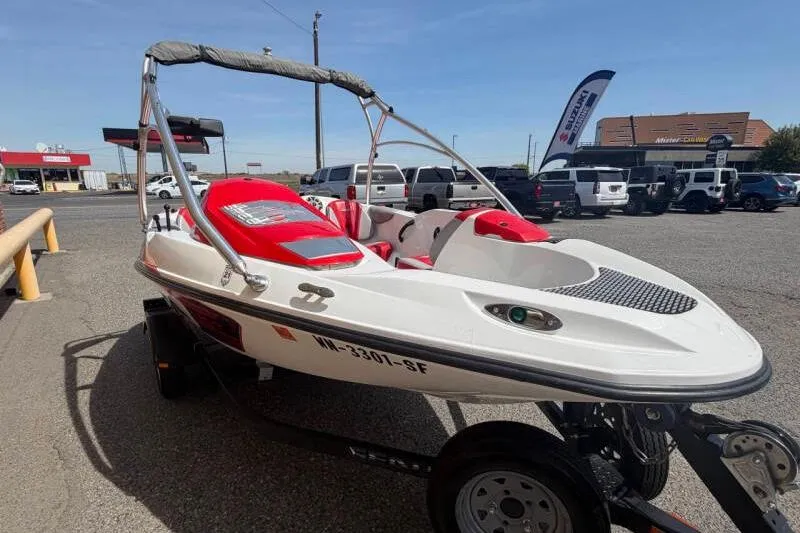 Slide: The Image of 2008 Sea-Doo 150 Speedster boat with red and white design on a trailer. - 2