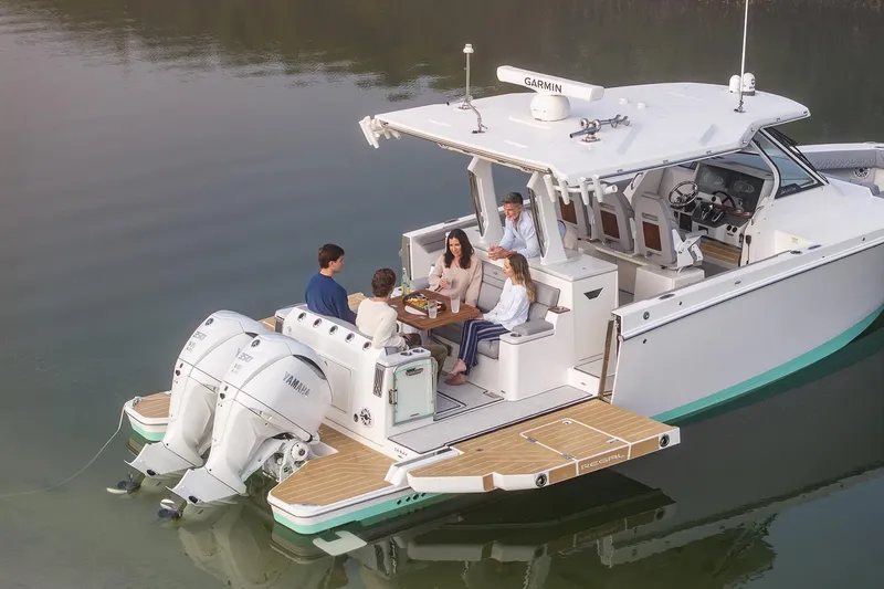 Slide: The Image of Manufacturer Provided Image: 2026 Regal 34 SAV boat with people enjoying a meal on deck. - 2