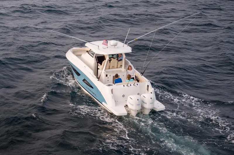 Slide: The Image of Manufacturer Provided Image: 2026 Regal 33 SAV boat cruising on open water, featuring dual outboard engines. - 3