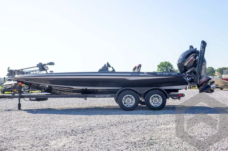 Slide: The Image of 2026 Skeeter ZXE20 boat on trailer, side view, outdoors on gravel. - 12