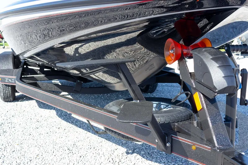 Slide: The Image of 2026 Skeeter ZXE20 boat trailer with sleek black hull and sturdy support frame. - 18