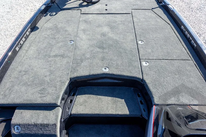 Slide: The Image of 2026 Skeeter ZXE20 boat deck with gray carpet and storage compartments. - 31