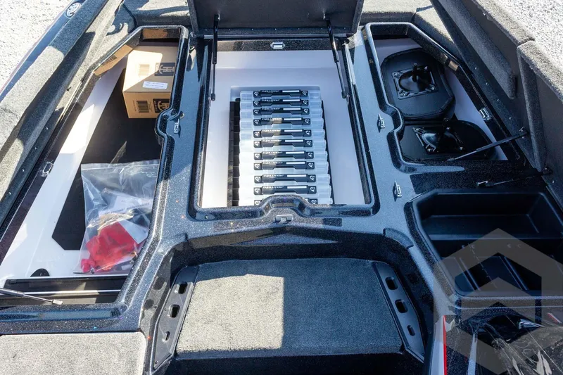 Slide: The Image of Interior view of 2026 Skeeter ZXE20 boat storage compartments and battery setup. - 32