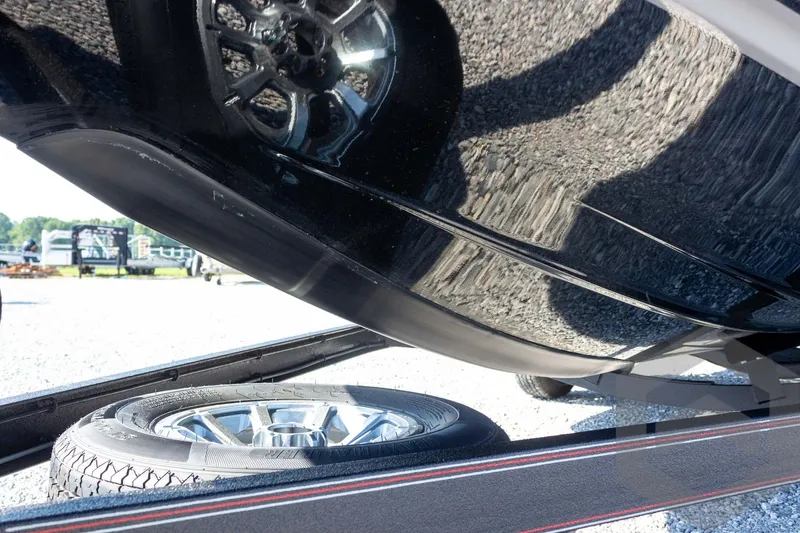 Slide: The Image of Underneath view of a 2026 Skeeter ZXE20 boat on a trailer, showcasing tire and hull. - 4