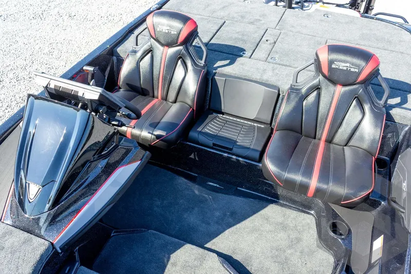 Slide: The Image of 2026 Skeeter ZXE20 boat interior with black and red seats, modern dashboard. - 40