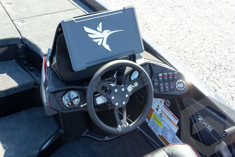 Slide: The Image of 2026 Skeeter ZXE20 boat dashboard with steering wheel and control panel. - 42