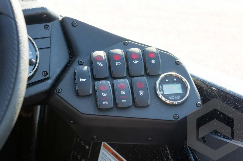 Slide: The Image of Control panel of 2026 Skeeter ZXE20 boat with various switches and digital display. - 44