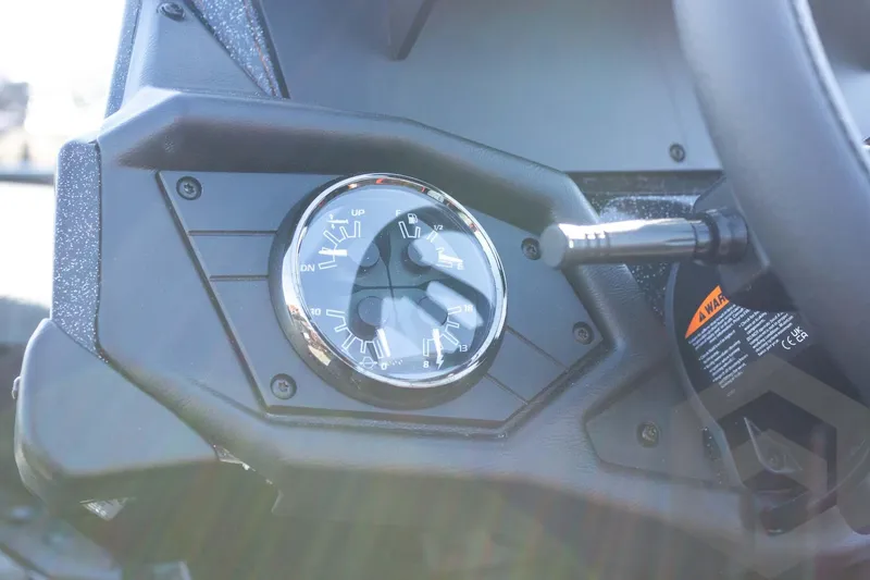 Slide: The Image of Dashboard of 2026 Skeeter ZXE20 boat featuring a gauge and control lever. - 46