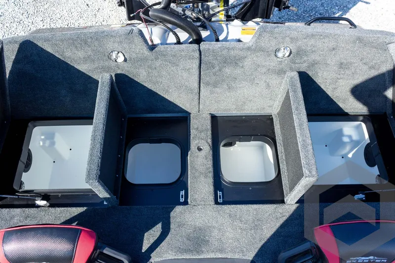 Slide: The Image of 2026 Skeeter ZXE20 boat storage compartments with open lids, showcasing interior design. - 51