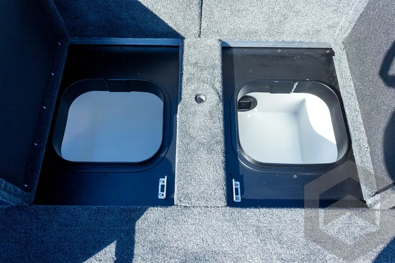 Slide: The Image of 2026 Skeeter ZXE20 boat storage compartments with open lids, showcasing interior design. - 52