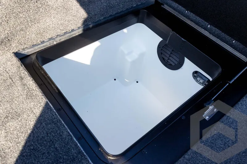 Slide: The Image of Storage compartment of 2026 Skeeter ZXE20 boat, featuring a clean, carpeted interior. - 54