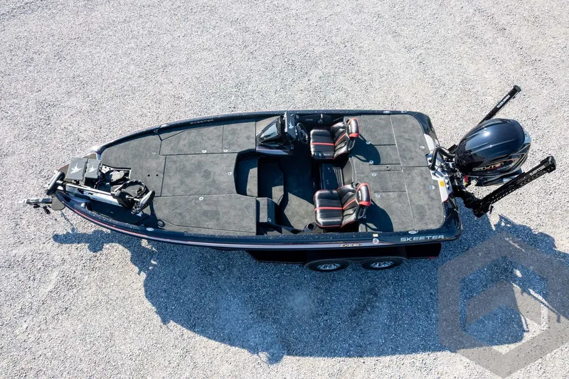 Slide: The Image of 2026 Skeeter ZXE20 fishing boat with dual seats and motor, viewed from above on gravel. - 61