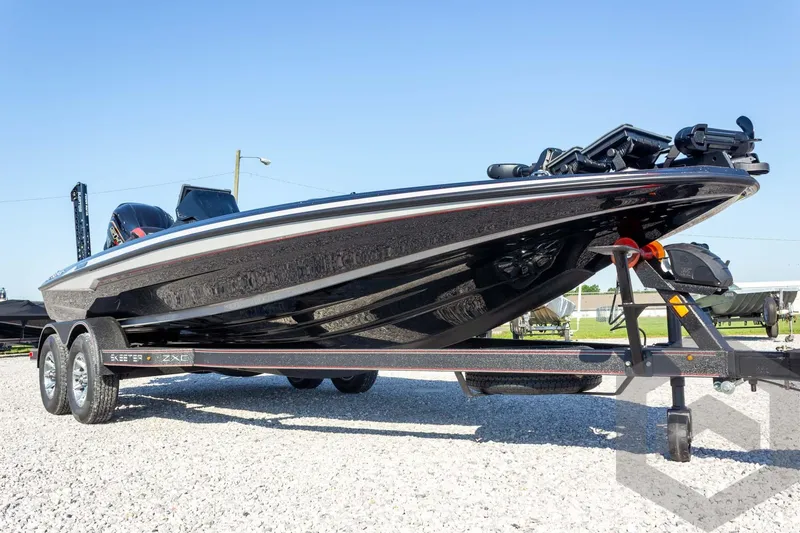 Slide: The Image of 2026 Skeeter ZXE20 boat on trailer, sleek design, parked on gravel under clear blue sky. - 7