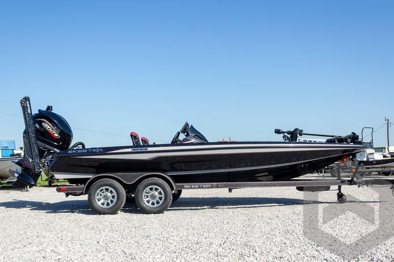 Slide: The Image of 2026 Skeeter ZXE20 boat on trailer, side view, outdoors on gravel. - 8
