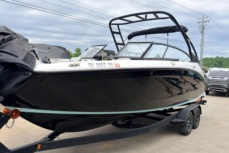 The Image of 2023 Yamaha Boats AR250 on trailer, sleek black design, ready for adventure. - 0