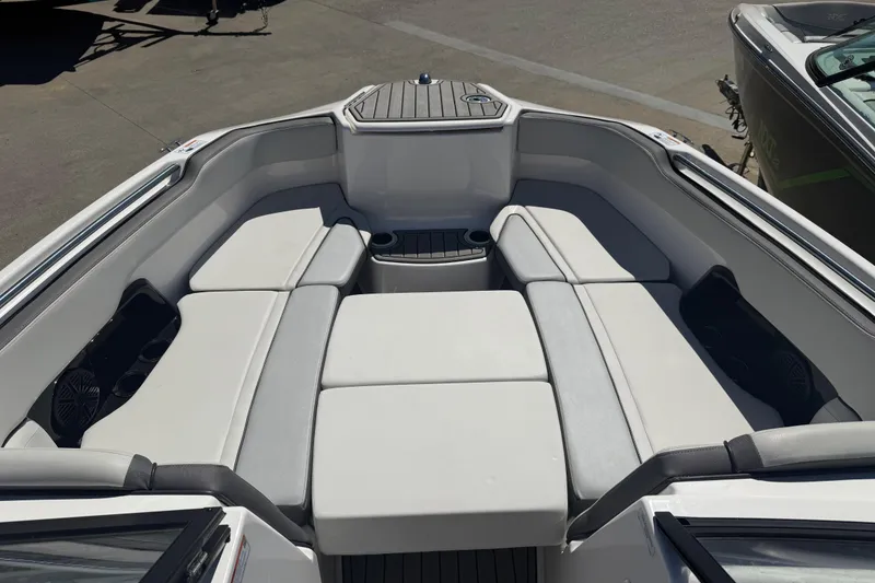 Slide: The Image of 2023 Yamaha Boats AR250 interior with cushioned seating and cup holders. - 11
