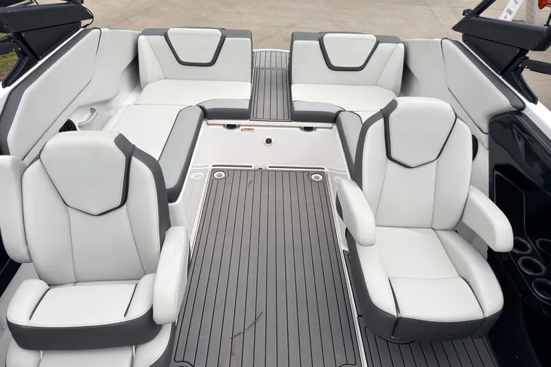 Slide: The Image of 2023 Yamaha Boats AR250 interior with sleek white seating and modern design. - 12