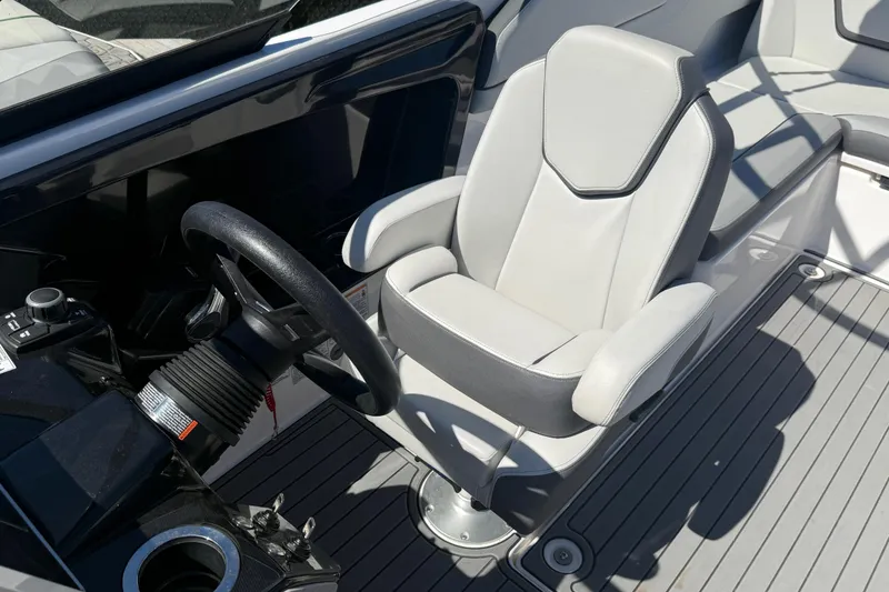Slide: The Image of 2023 Yamaha Boats AR250 cockpit with steering wheel and comfortable seating. - 14