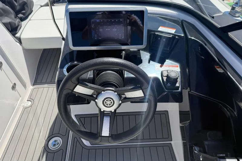 Slide: The Image of 2023 Yamaha Boats AR250 dashboard with steering wheel and touchscreen display. - 15