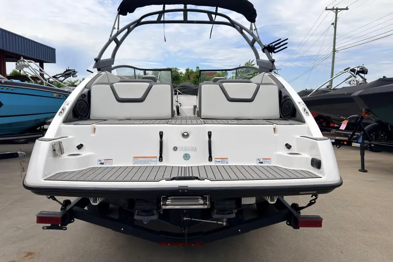 Slide: The Image of 2023 Yamaha Boats AR250, rear view, showcasing sleek design and spacious seating. - 2