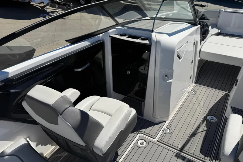 Slide: The Image of 2023 Yamaha Boats AR250 interior with seating and storage compartment. - 23